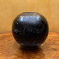 Round Black Sphere With Bronze Vase 